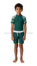 Boy wearing a short-sleeve rash guard with hammerhead shark print and swim shorts