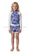 Girl wearing long-sleeve swimwear with blue ripple print