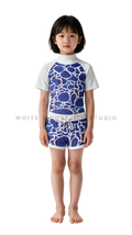 Girl wearing short-sleeve swimwear with blue ripple print